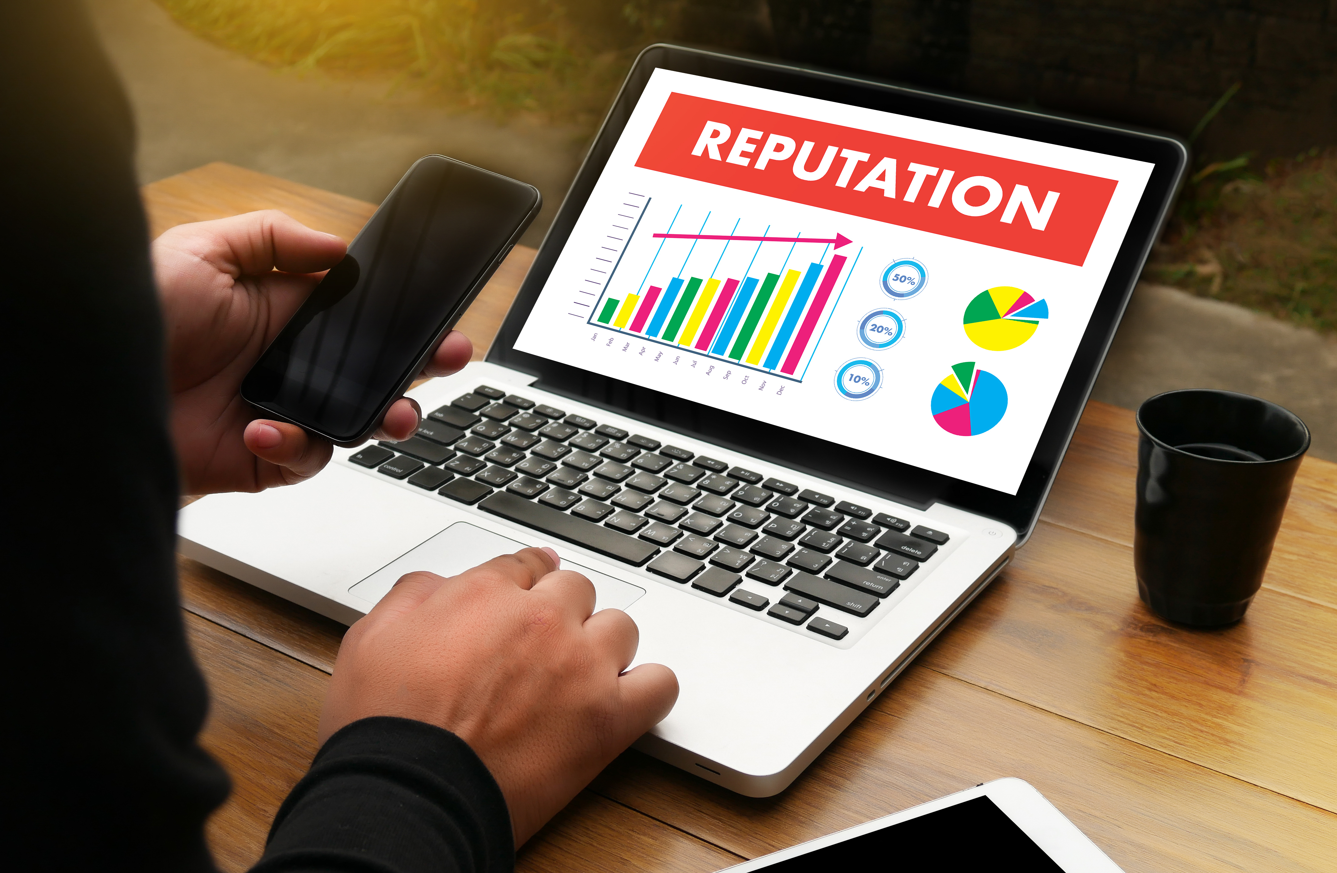 Worker's laptop with screen showing reputation increasing