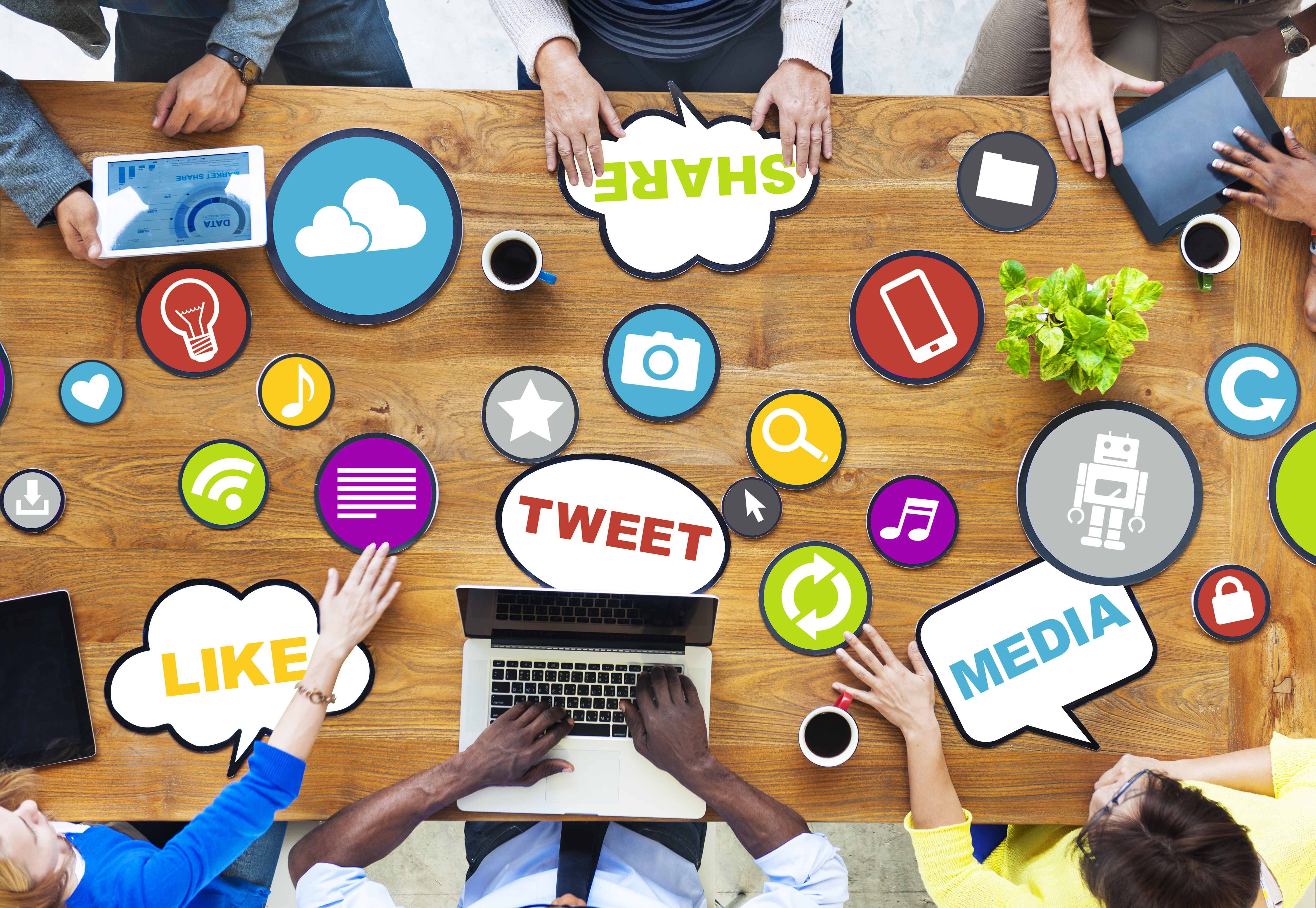 Meeting table covered with many social media icons
